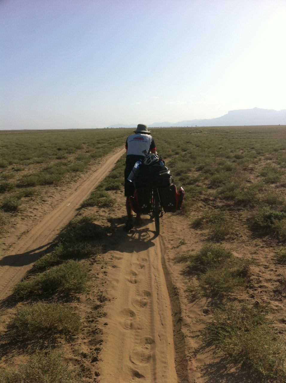 Hauling our bikes through the sand in the no-mans-land between Ethiopia, South Sudan and Kenya