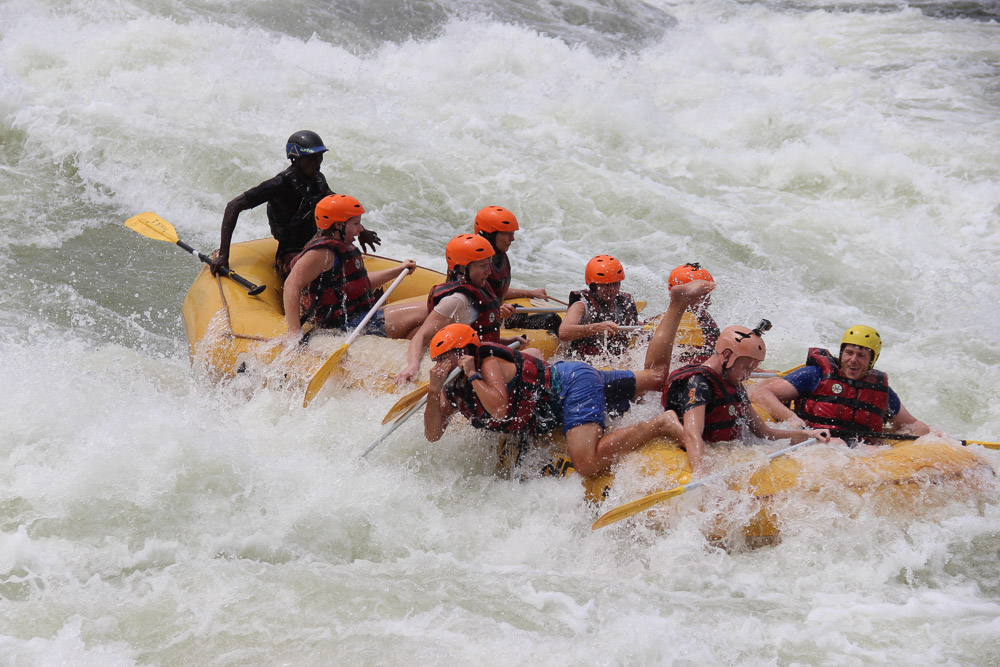 Emily (in the blue shorts) manages to hold her nose as she takes another tumble form the raft
